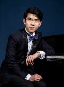 Portrait of Aristo Sham seated at a Piano